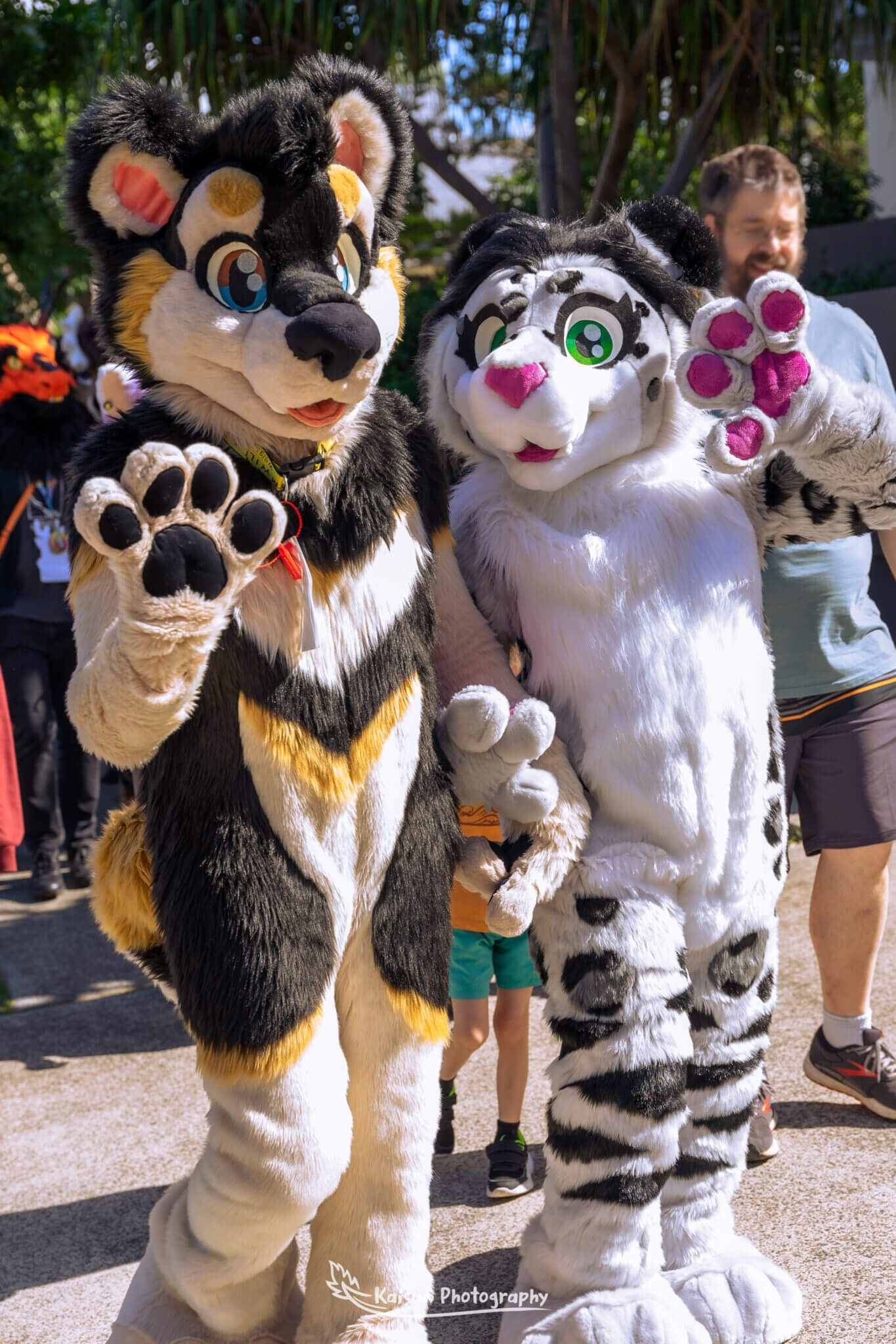 2 Fursuiters waving at the camera